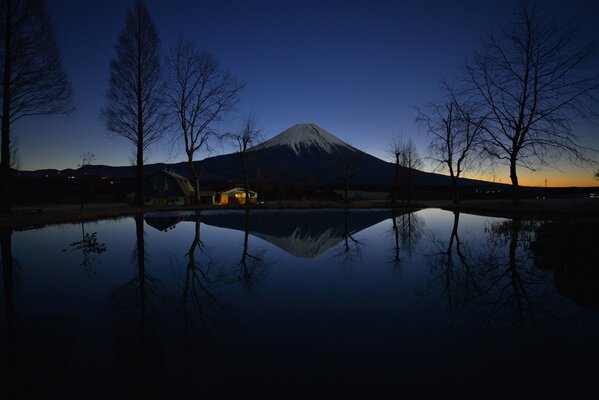 Mount Fujiyama in the evening against the background of lights