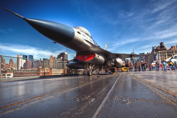 Fighter jet on the runway against the background of the city