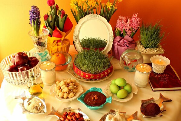 A table with flowers , treats and candles for a festive holiday on a memorable date