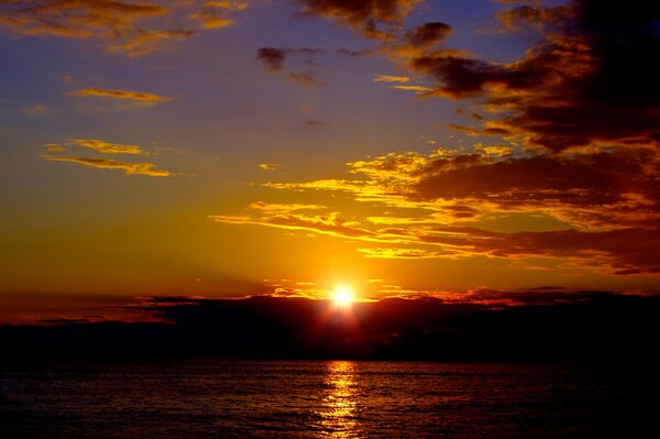 The sun sinks into the warm sea