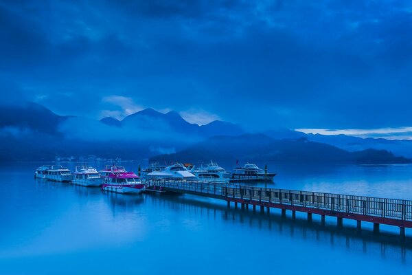 Jetty with boats and blue sky