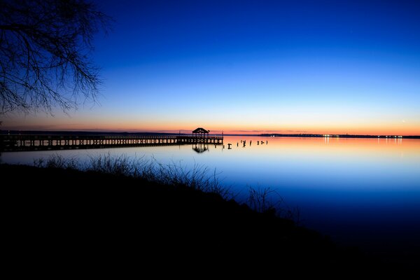 A pier in Virginia in the middle of a calm in the rays of sunset
