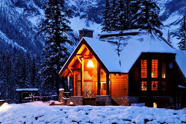 A house in winter nature among mountains and trees ьев