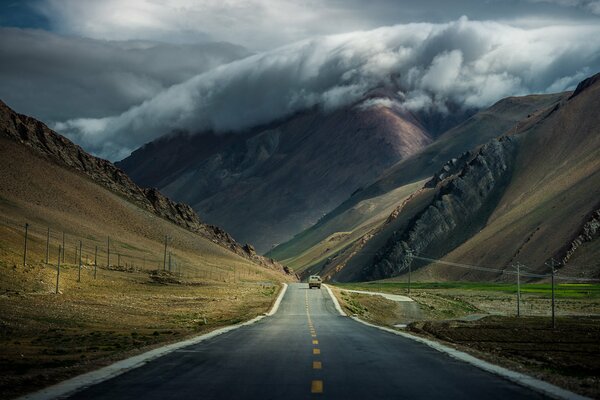 Tibetan mountains by the road under the clouds