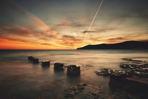 The rocky coast of Ibiza in the rays of the setting sun