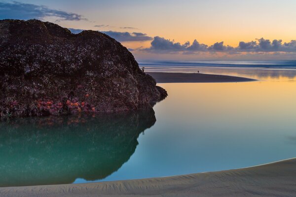 Sunset on the coast on the background of a cliff
