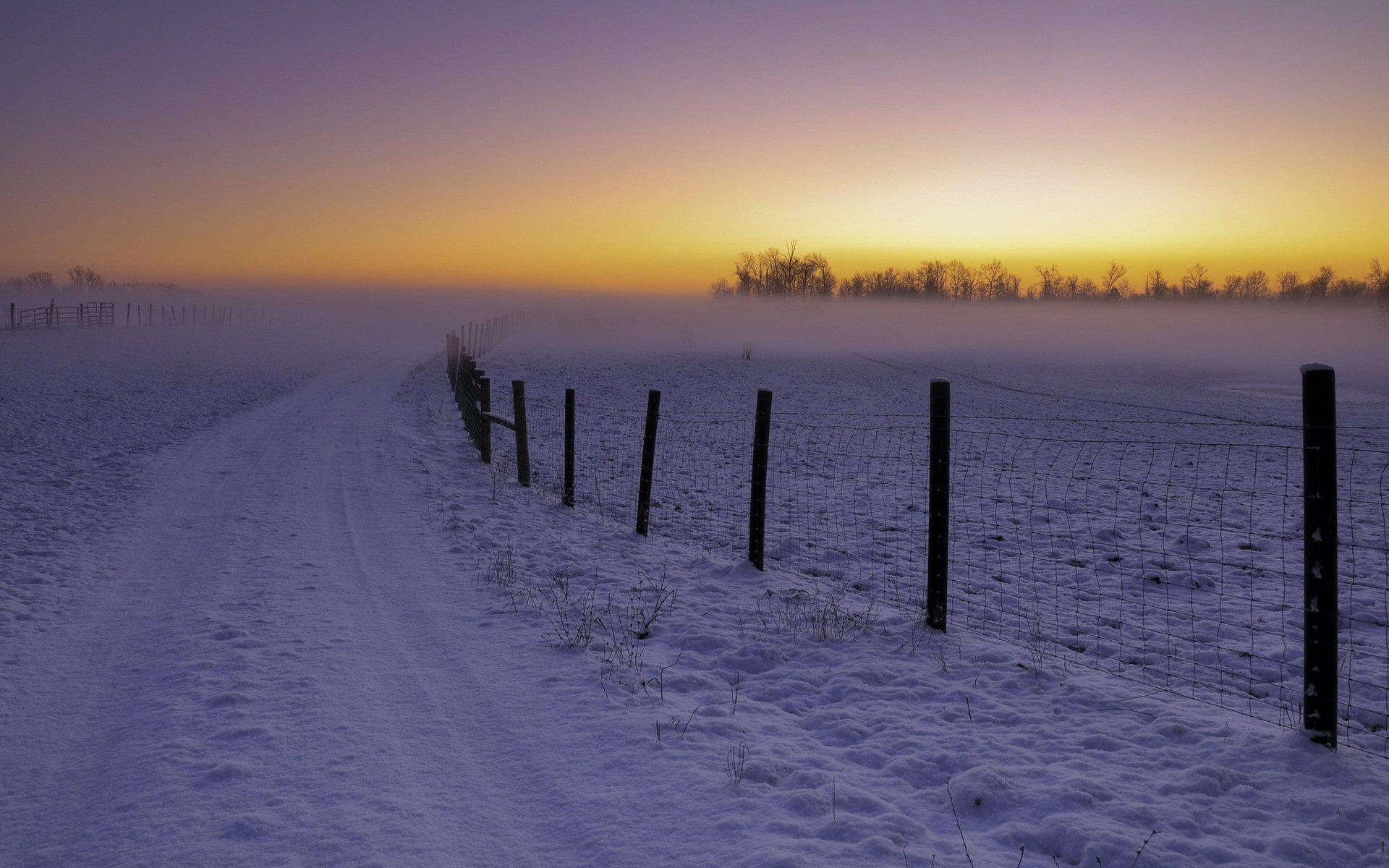 unset winter landscape fence road