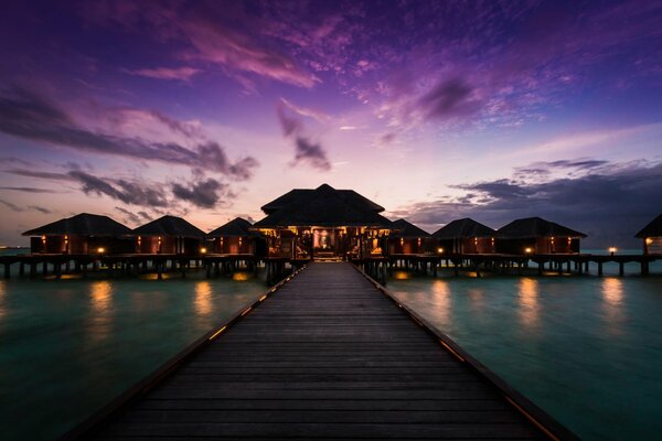 View from the pier to the bungalow hotel in the Maldives