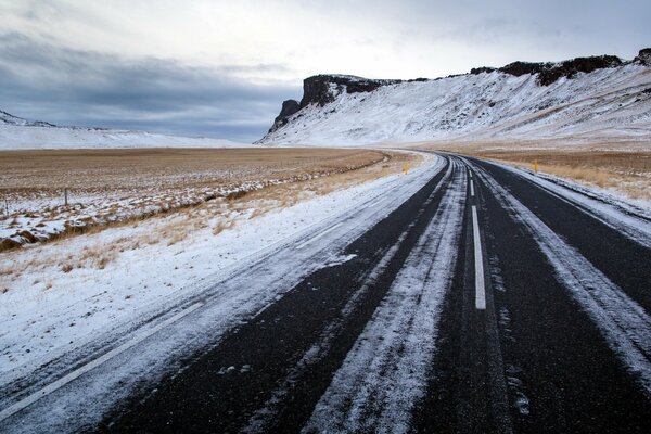 Winter road to the dark mountains